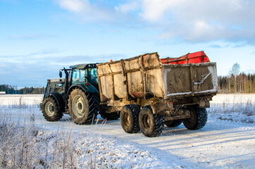 Fototapeta premium A tractor truck on a snowy countryside road, Turi, Estonia