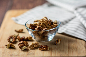 Walnut on a wooden table. Walnuts in a glass plate and walnut  on a wooden table.