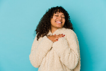 Young african american afro woman isolated laughing keeping hands on heart, concept of happiness.