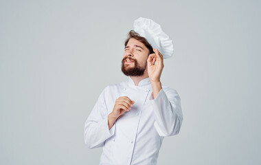 Emotional chef in a headdress gestures Copy Space hands