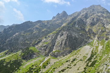 Fototapeta premium Beautiful summer landscape with rocky mountain peaks at High Tatras mountains, Slovakia. Hiking adventure.
