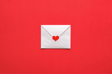Valentine's card on a red background. White envelope with red heart