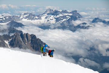 Mountain climbers on Mont Blanc set against the impressive panorama of the French Alps