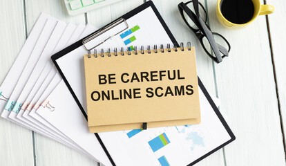 be careful online scams word on notepad, business concept