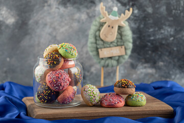 Colorful sweet doughnuts with Christmas deer toy