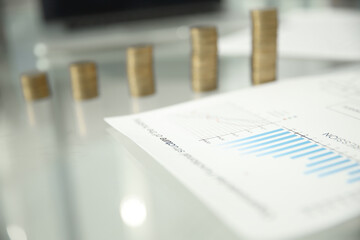 business background. financials and stacks of coins on the offic