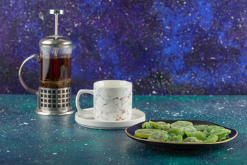 Obraz na płótnie Canvas A glass teapot with dried kiwi fruit on a bright background