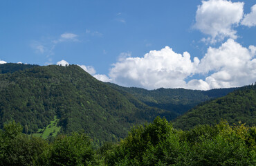 View of the mountains, blue sky with fluffy clouds. Summer landscape