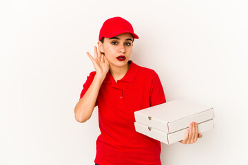 Young skinny arab pizza delivery girl relaxed thinking about something looking at a copy space.