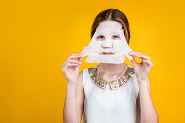 girl child using beauty facial mask, copy space, collagen