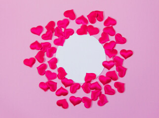 Pink hearts on pink background around round card for text, Valentine's day love concept