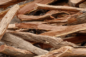 many pieces of wood stacked in a pile to form an interesting pattern
