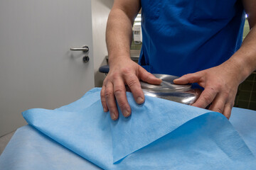 in  hospital sterilization department, a surgical saline dish is wrapped in paper