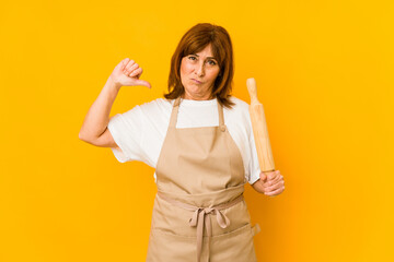 Middle age caucasian cook woman holding a roller isolated feels proud and self confident, example to follow. - Powered by Adobe