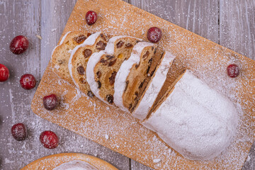 Christmas marzipan stollen cake with icing sugar, marzipan and raisins.