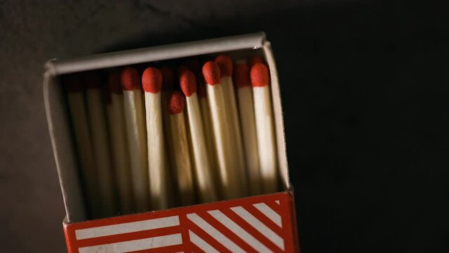 Close view of matchbox half full of fresh matches on table