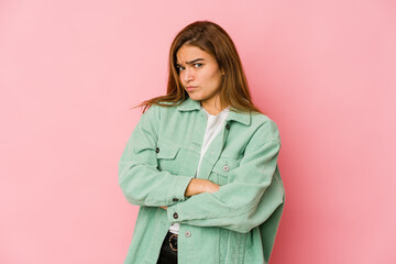 Young skinny caucasian teenager girl unhappy looking in camera with sarcastic expression.