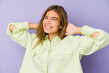 Young skinny caucasian girl teenager on purple background stretching arms, relaxed position.