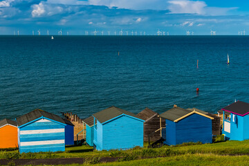 A view across the beach huts at Tankerton out into the Thames Estuary in summer
