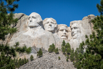 The Carved Busts of George Washington, Thomas Jefferson, Theodore “Teddy” Roosevelt, and Abraham Lincoln at Mount Rushmore National Monument - obrazy, fototapety, plakaty