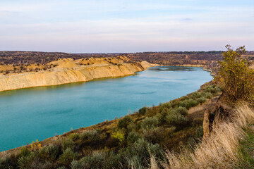 Obraz premium Lake with sandy bank in the abandoned coal quarry