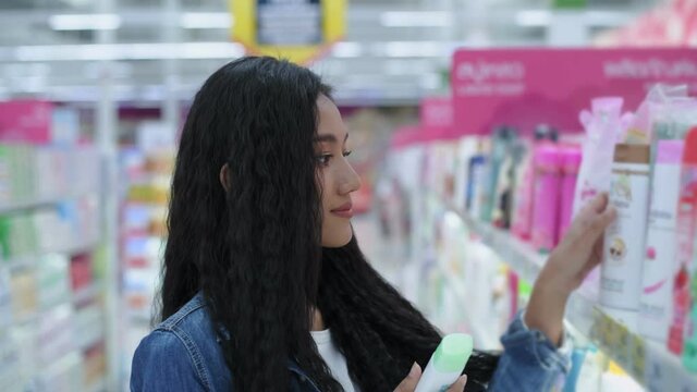 Department store concept of 4k Resolution. Asian women are buying shower cream in a shopping mall.