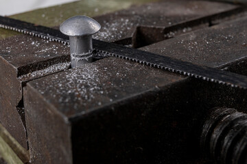 Cutting aluminum with a handsaw. Locksmith works performed as an amateur.