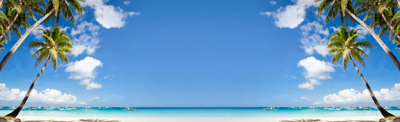 Tropical beach with coconut palm trees, white sand and turquoise sea. Travel concept. Long banner