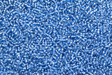 Background texture of blye beads closeup. Seamless beads texture. Hobbies, handmade jewelry, craft. Abstract background