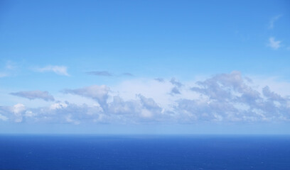 View from the coast of the Easter Island, of blue sky covered by white clouds, over the Pacific...