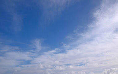 Naklejka premium View from the coast of the Easter Island, of blue sky covered by white clouds, over the Pacific Ocean.