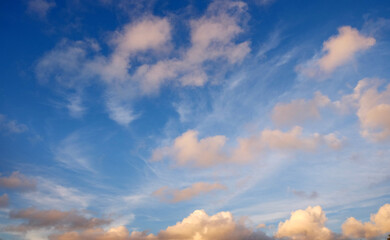 View from the coast of the Easter Island, of colorful sunset sky covered by white clouds, over the Pacific Ocean.