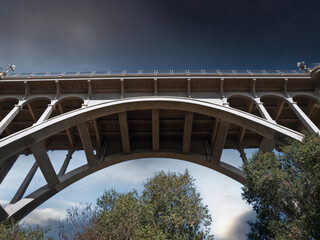 View of the historic Colorado Blvd Bridge with stormy sky in scenic Pasadena, California.