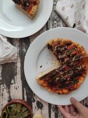 Homemade pizza with flatbeans on an old wood table