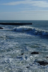 A big wave breaking in the small harbour of Batz sur mer. (West of France, december 2020)