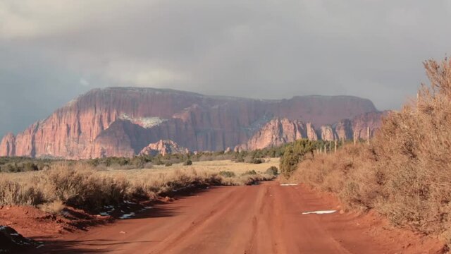 Cloud shadows drift across the cliffs of the Kolob fingers mountains at four times real speed, in Southern Utah on a cold windy winter day.