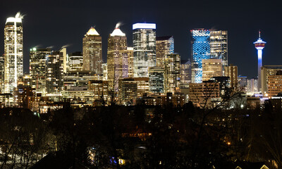 Fototapeta premium A long exposure of downtown office building lights and the Calgary Tower at night.