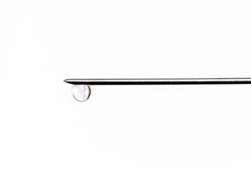 Needle with drop isolated on white background, macro.