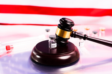 Adverse effects of the vaccine are claimed in court seeking compensation, gavel on vial of vaccines.