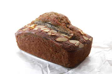 Banana bread with walnuts on white background