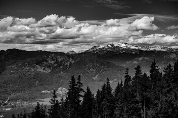 Breathtaking black and white view of the  mountains peaks, forests, and clouds in Whistler, British Columbia, Canada