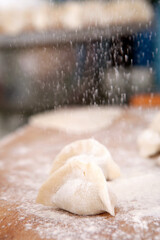Fototapeta na wymiar Sprinkle flour on the dumplings