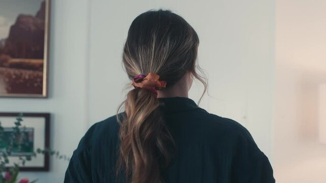 Young woman putting on safety glasses and turning around, Closeup