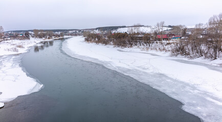 The spring river in the village began to thaw from the ice.The ice in the river began to melt.