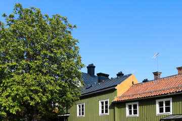 Houses and trees in a blue sky background in Sweden