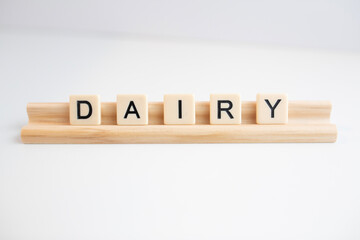 the word dairy written in scrabble titles against a white background