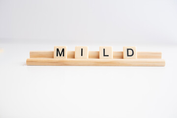 the word mild written in scrabble titles against a white background