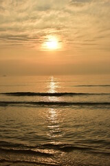 Sunset at the beautiful beach view Among the many people come to play in the sea before the dusk.silhouette of sunset at beach.
