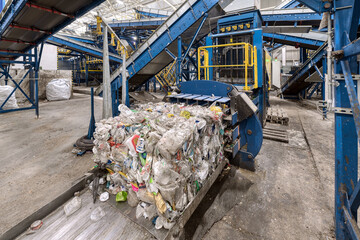 Household waste sorting and recycling plant. Press for pressing plastic bottles