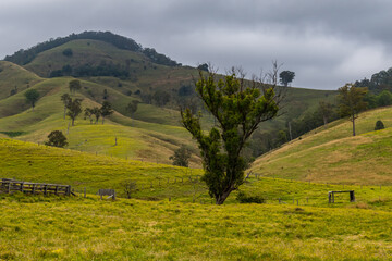 Overcast day in the country surrounded by rural land and hills